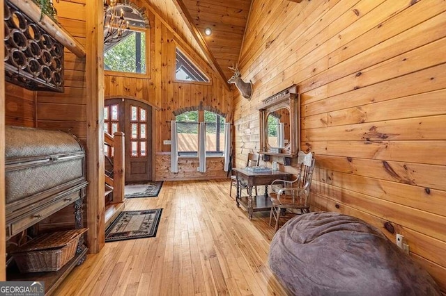 sitting room featuring wood ceiling, high vaulted ceiling, light wood-type flooring, and a wealth of natural light