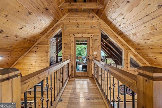 interior space with wood ceiling, wood walls, hardwood / wood-style floors, and vaulted ceiling