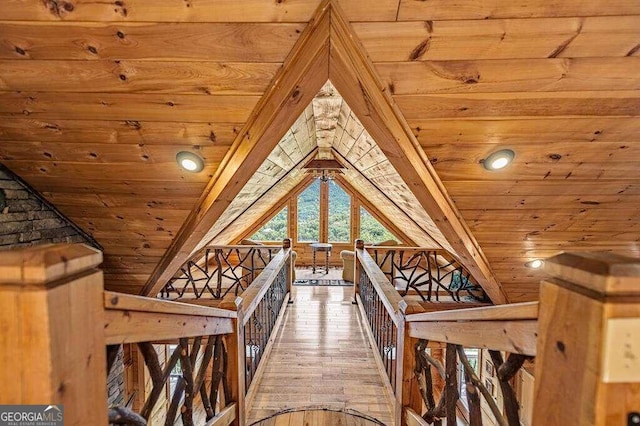 interior space featuring wood ceiling, wood-type flooring, and vaulted ceiling with beams