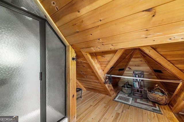 bonus room with light hardwood / wood-style floors, vaulted ceiling with beams, and wooden ceiling