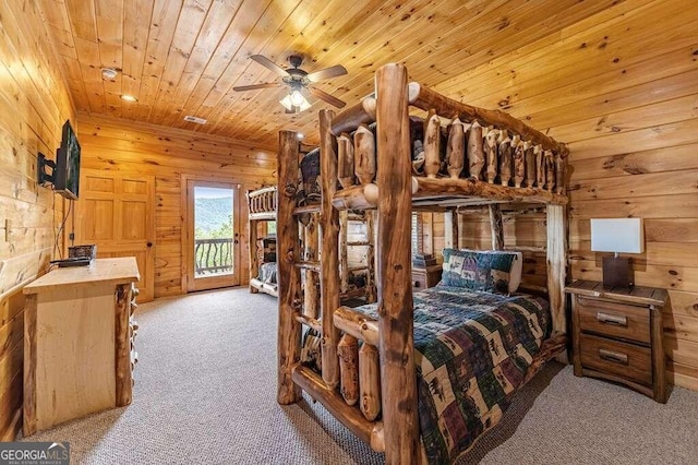 bedroom featuring wood ceiling, access to exterior, ceiling fan, wooden walls, and light colored carpet