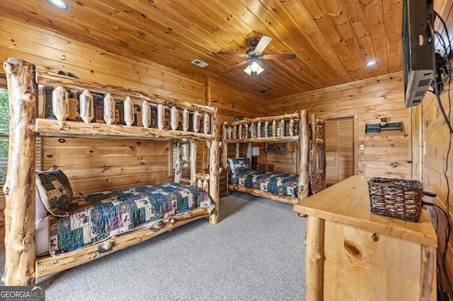 bedroom with wood ceiling, wooden walls, carpet, and ceiling fan