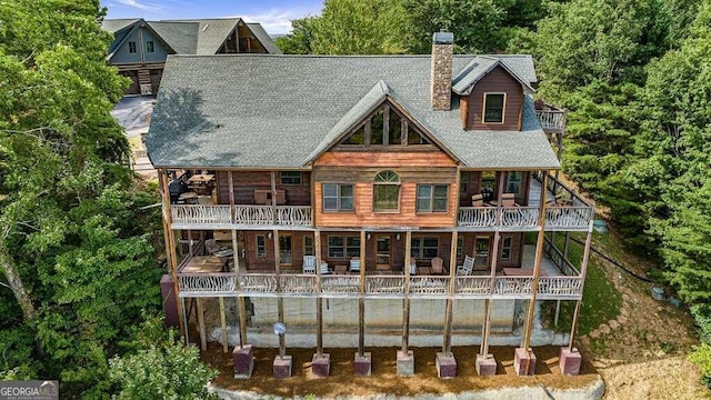 rear view of property featuring a balcony