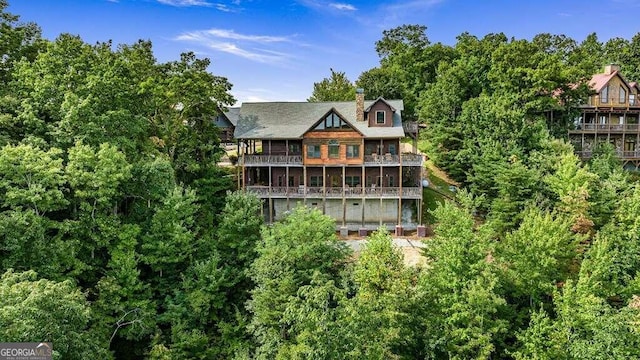 rear view of property featuring a balcony