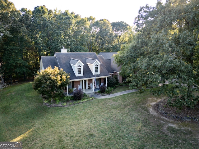 cape cod-style house with a front lawn