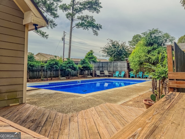 view of swimming pool featuring a wooden deck