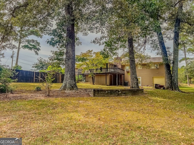 view of yard with a wooden deck and a garage