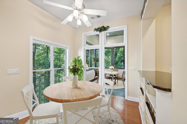 dining room with ceiling fan and dark hardwood / wood-style floors