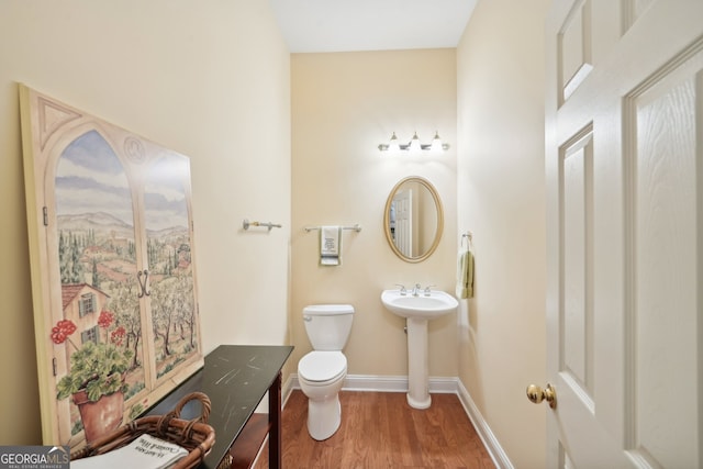 bathroom featuring toilet and hardwood / wood-style flooring