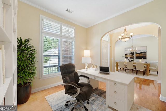 office with ornamental molding, a notable chandelier, and light hardwood / wood-style floors