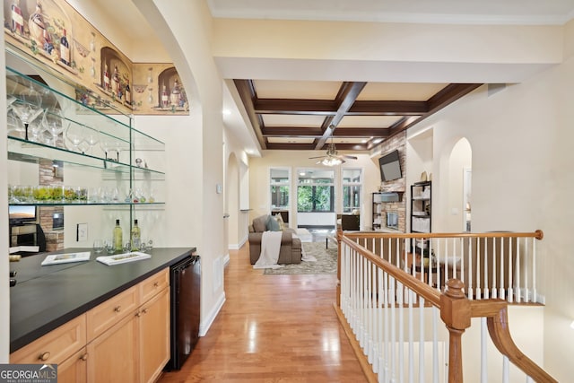 bar featuring coffered ceiling, light hardwood / wood-style flooring, light brown cabinetry, ceiling fan, and beam ceiling