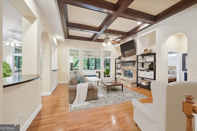 living room featuring plenty of natural light, ceiling fan, and light hardwood / wood-style flooring