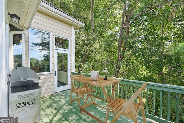 wooden deck with a grill