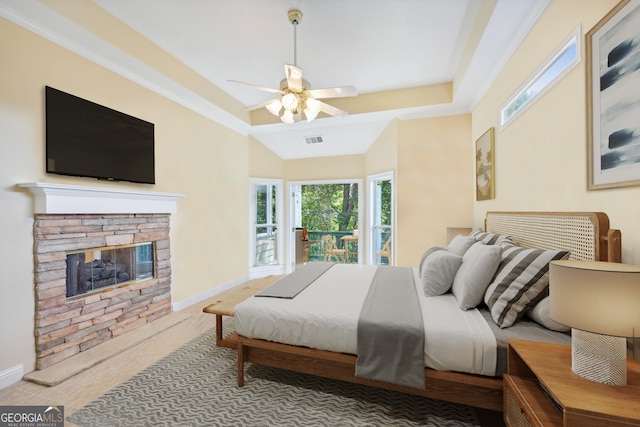 bedroom with a fireplace, ceiling fan, and carpet