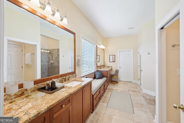 bathroom featuring tile patterned floors, walk in shower, and vanity