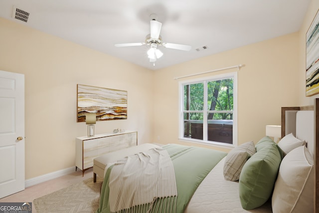 bedroom featuring light carpet and ceiling fan