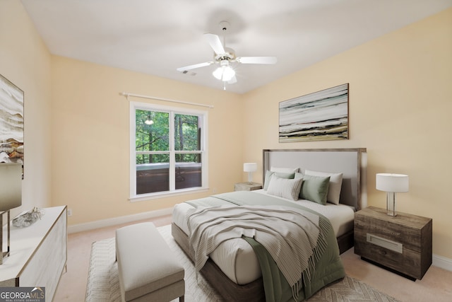 bedroom featuring ceiling fan and light carpet