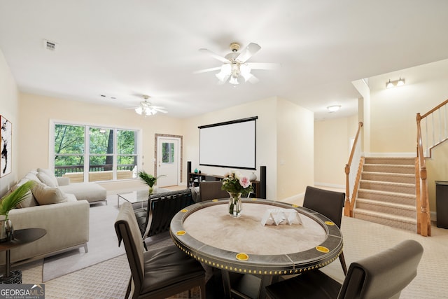 carpeted dining room with ceiling fan