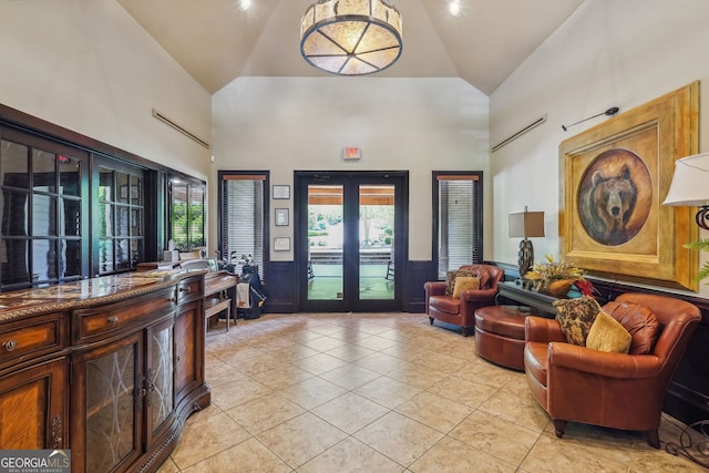 interior space with french doors, high vaulted ceiling, and light tile patterned flooring