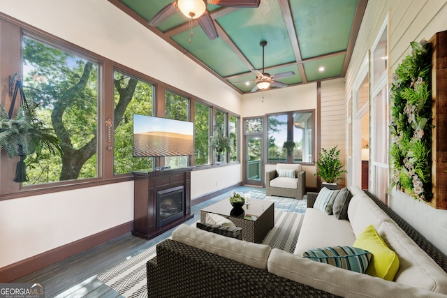 sunroom / solarium featuring ceiling fan