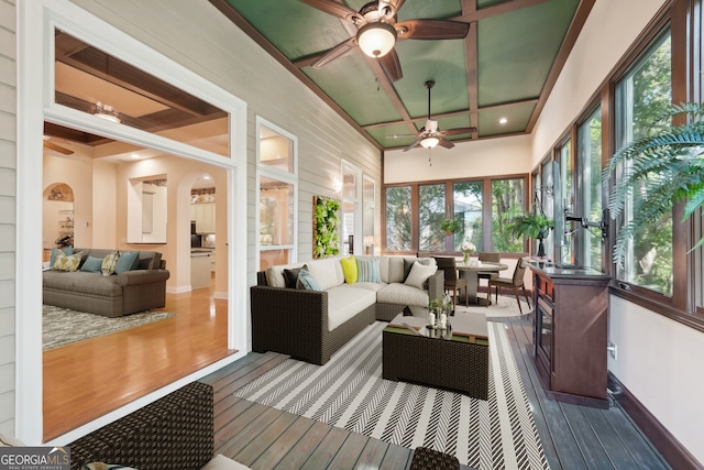 sunroom / solarium featuring coffered ceiling and ceiling fan