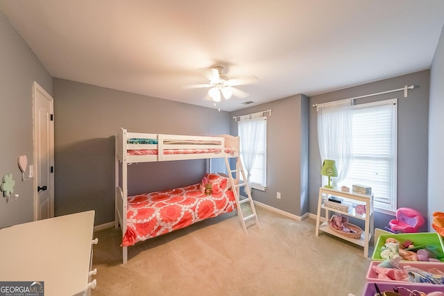 bedroom featuring baseboards, a ceiling fan, visible vents, and light colored carpet