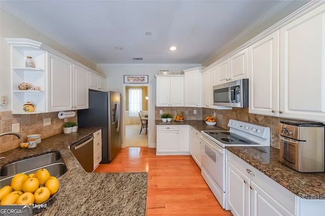 kitchen with white cabinets, open shelves, and stainless steel appliances