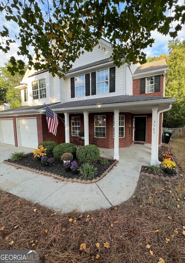 view of front of property with covered porch and a garage