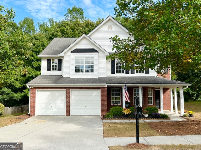 front of property featuring a porch and a garage