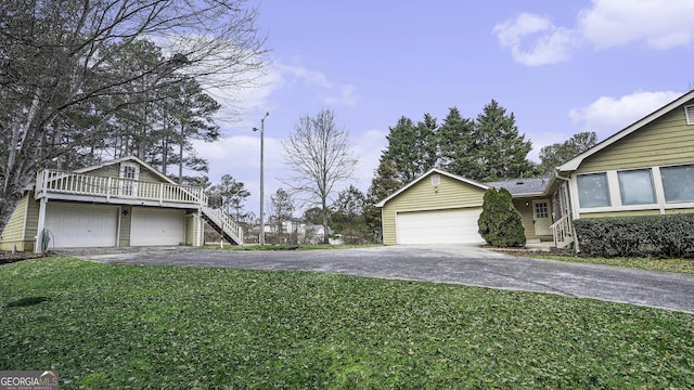 2601 Round Ridge Rd, Loganville, GA 30052 - exterior space featuring driveway, a garage, and a yard
