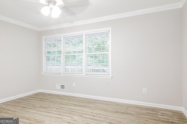 spare room featuring visible vents, baseboards, light wood-style floors, and ornamental molding