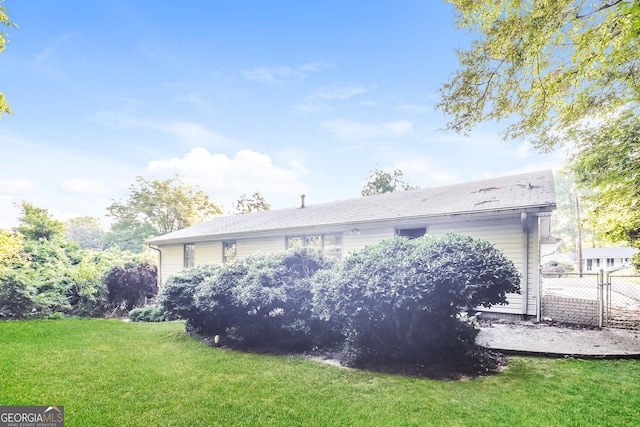 back of property featuring a yard and fence