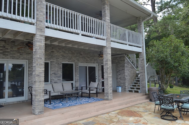 wooden terrace featuring outdoor lounge area and a patio area