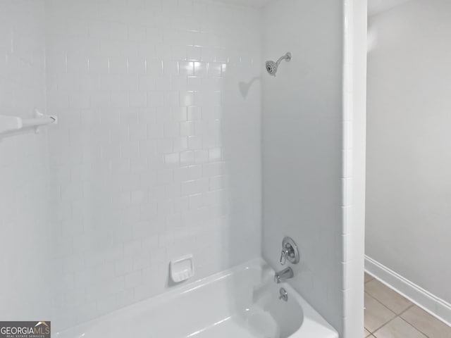 full bathroom featuring tile patterned floors, baseboards, and  shower combination