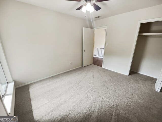 unfurnished bedroom featuring a closet, ceiling fan, and light colored carpet