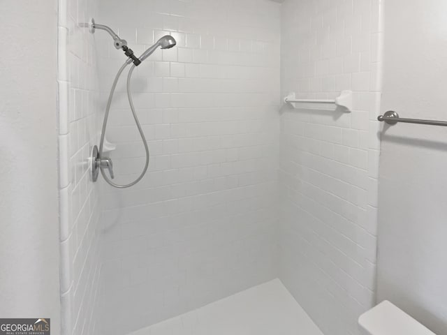 bathroom with tiled shower