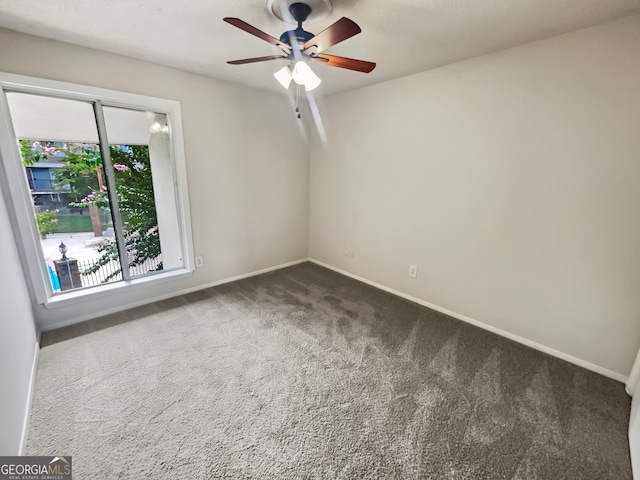 unfurnished room featuring ceiling fan and carpet