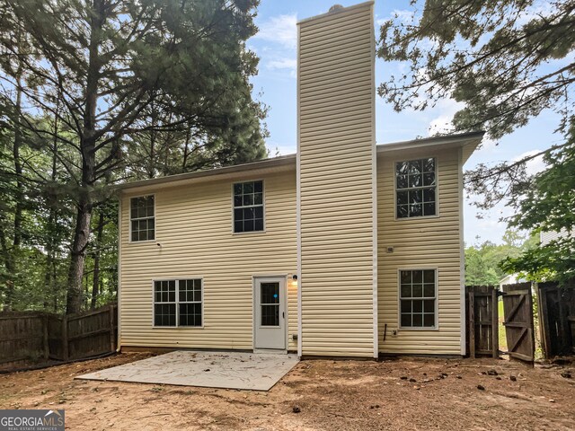 back of house with a patio area