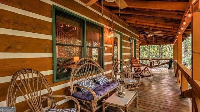 sunroom / solarium with lofted ceiling with beams and ceiling fan