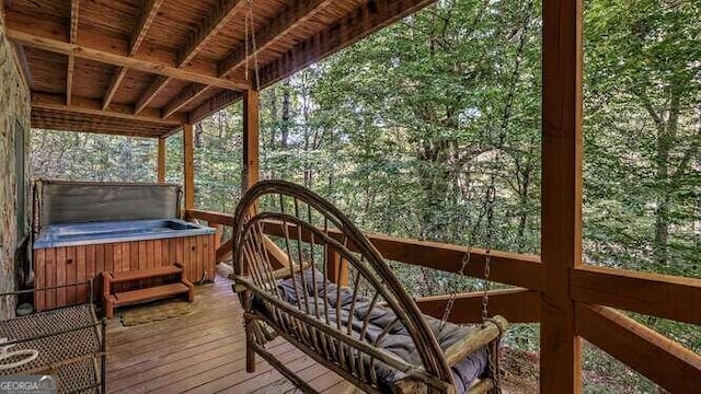 wooden deck with a hot tub