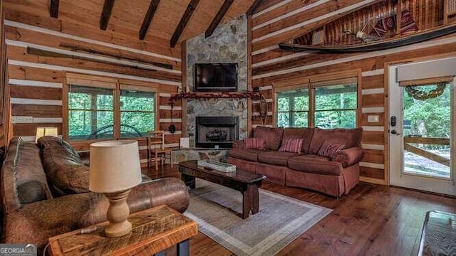 living room with a fireplace, beamed ceiling, high vaulted ceiling, wood-type flooring, and wood ceiling