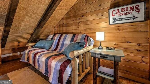 bedroom with lofted ceiling and wooden walls