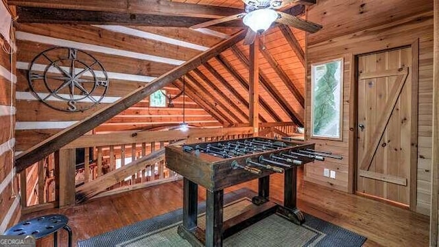 interior space with ceiling fan, hardwood / wood-style flooring, wooden walls, and wooden ceiling