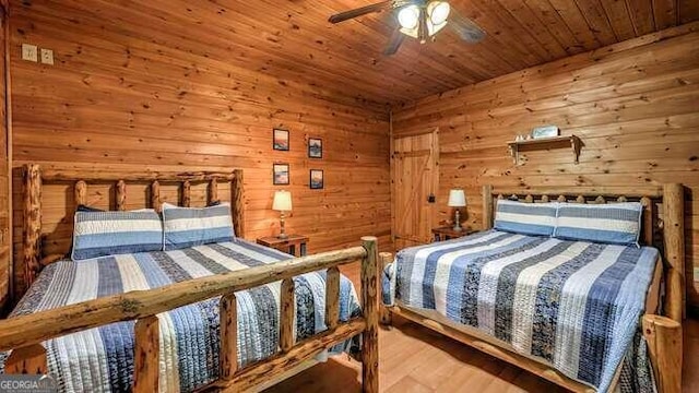 bedroom featuring wooden ceiling, wood-type flooring, wood walls, and ceiling fan