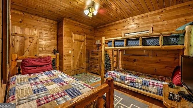 bedroom featuring wooden ceiling, hardwood / wood-style floors, and wood walls