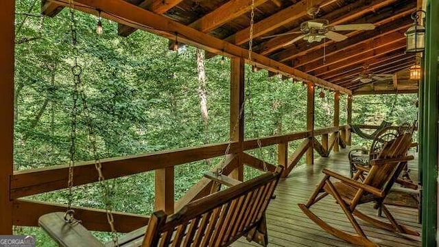 wooden terrace featuring ceiling fan