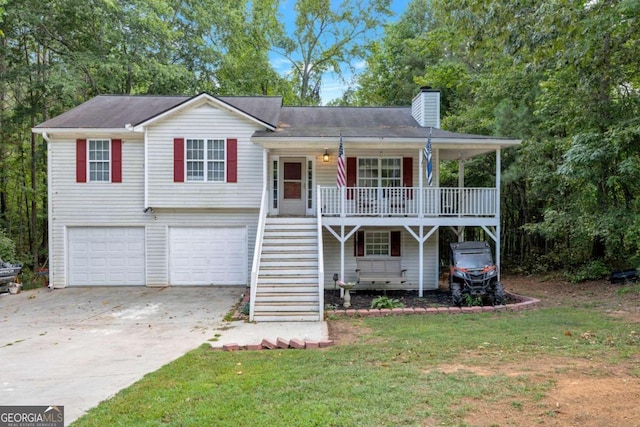 view of front of property featuring a garage, a porch, and a front lawn