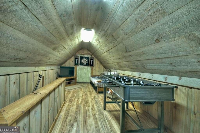 bonus room featuring lofted ceiling, wood ceiling, hardwood / wood-style flooring, and wooden walls