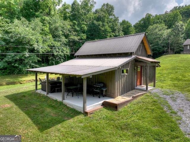 exterior space featuring a lawn and a patio area