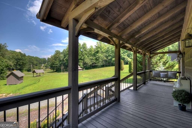 deck with a lawn and a shed